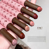 Set of pink and brown lipsticks with decorative design on a neutral background