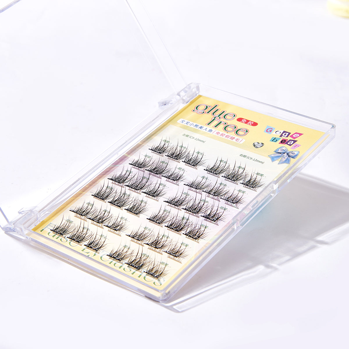 Set of false eyelashes in a clear case with a colorful label on a white background