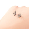 False eyelashes on a person's eyelid against a white background