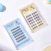 Two packages of false eyelashes on a white background