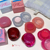 Set of small containers with lids, some labeled 'Gege bear', on a light surface.