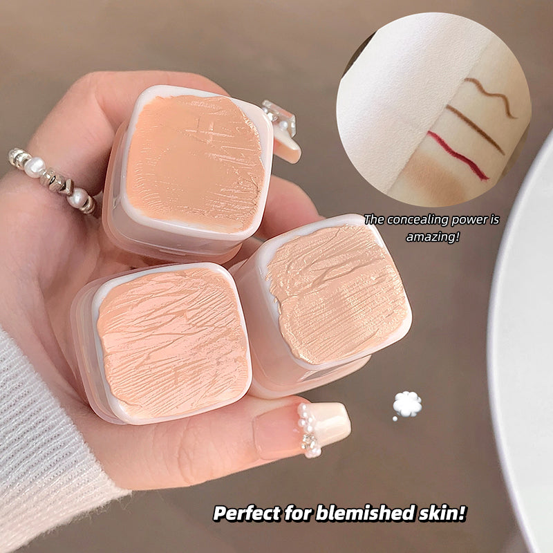 Hand holding cosmetic concealer with text highlighting its use for blemished skin.