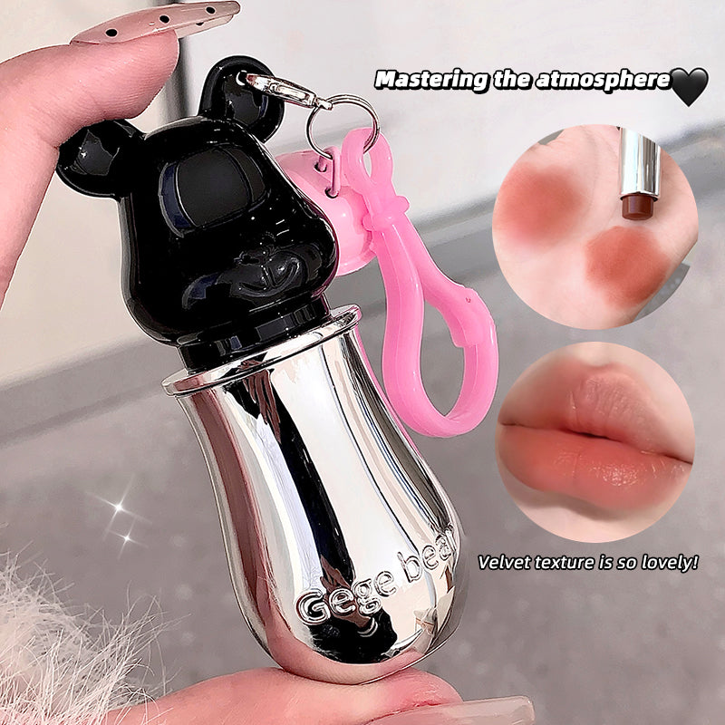 Lip gloss with a keychain held by a hand, surrounded by close-up images of lips and lip gloss.