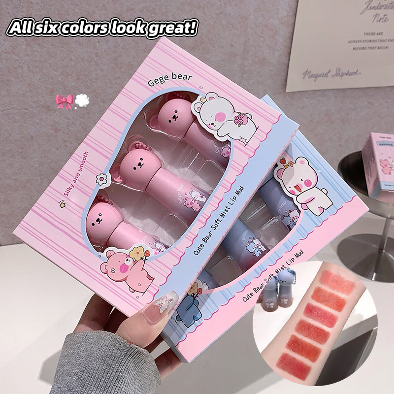 Pink lip balm set with bear design in packaging, held by a hand.