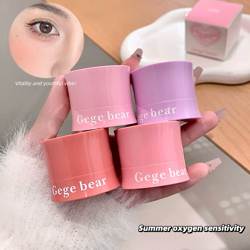Four small containers labeled 'Gege bear' held by a hand with a blurred background.