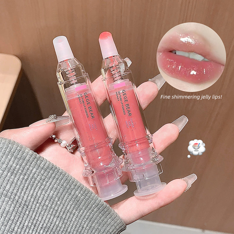 Two lip glosses held in a hand with a close-up of lips wearing the product.