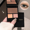 Makeup palette with four shades held by a hand, close-up of eye wearing glittery makeup.