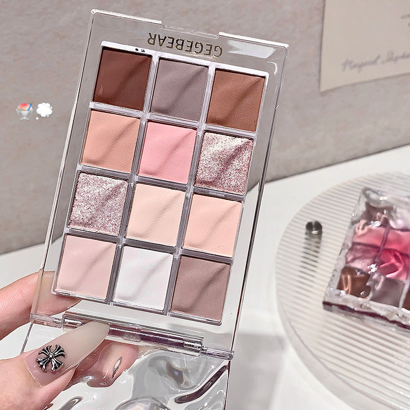 Makeup palette with various shades held by a hand, brand 'GEGEBEAR' visible.
