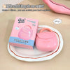 Pink mini bag with packaging on a beige surface