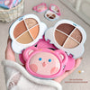 Makeup palette with cartoon face design held by a hand