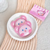 Pink bear-shaped containers with a box labeled 'Cute Bear' on a wooden surface.