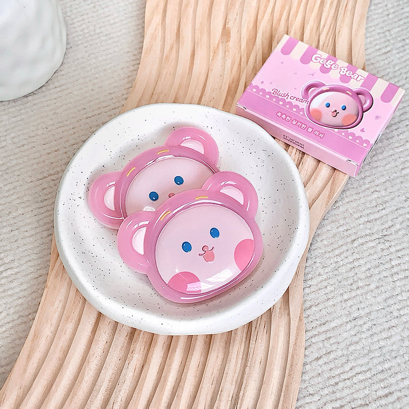 Pink bear-shaped containers with a box labeled 'Cute Bear' on a wooden surface.