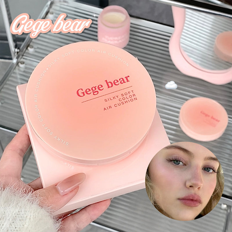 Pink air cushion compact with 'Gege bear' branding held by a hand, with a blurred inset of a person's face.
