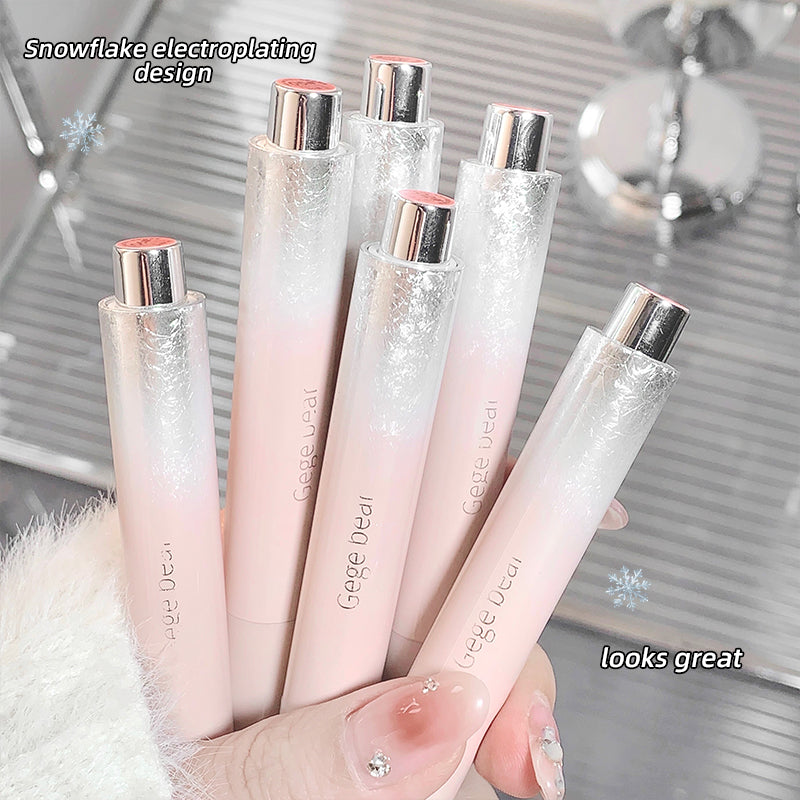Set of GEUGEUEUL lipsticks with snowflake electroplating design held by a hand.