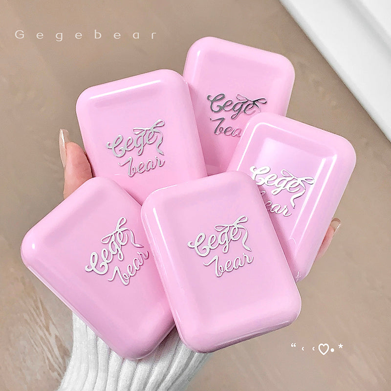 Pink containers with 'Gegebear' branding held by a hand on a neutral background