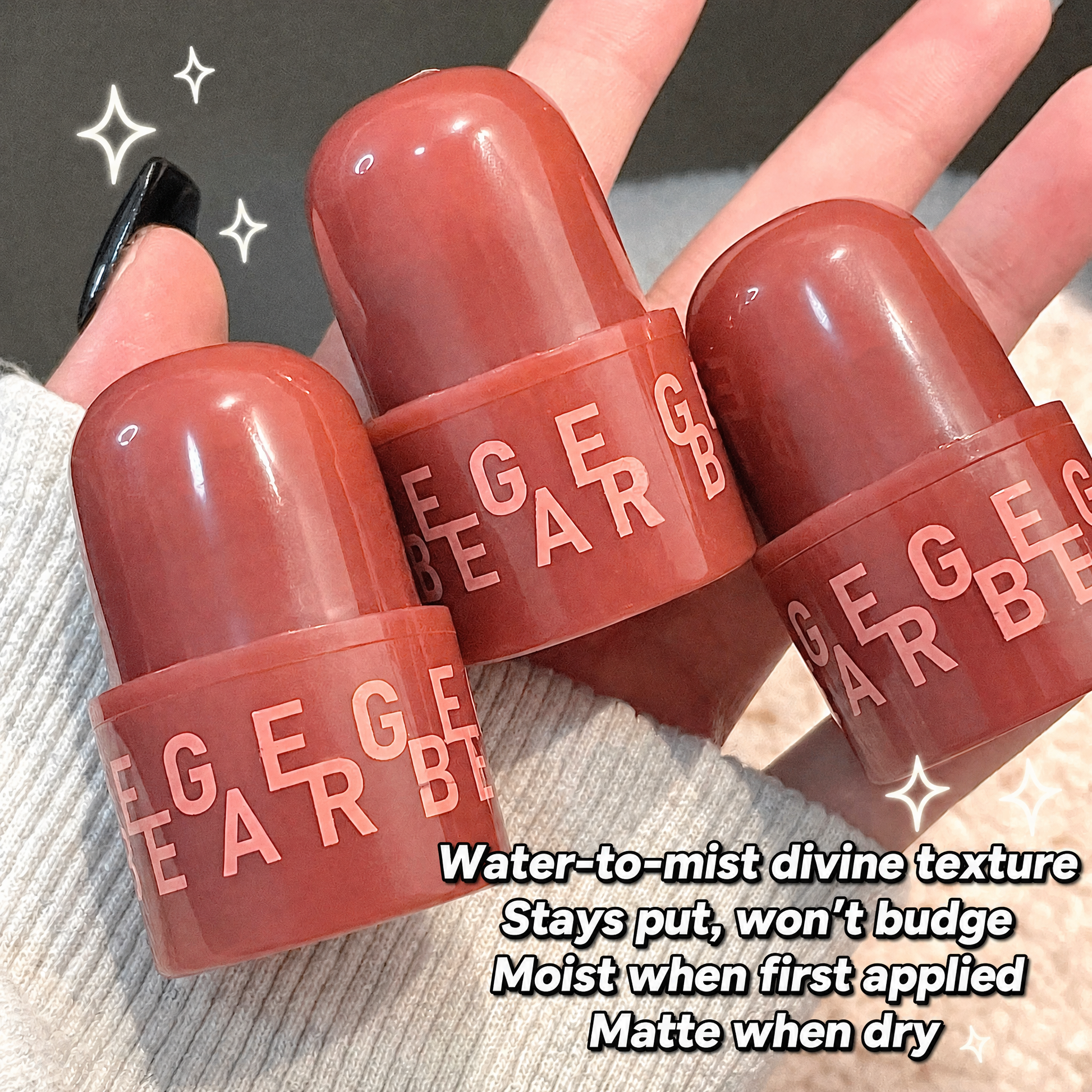 Three red lip balm tubes with 'GEGE' branding held by a hand on a textured surface.