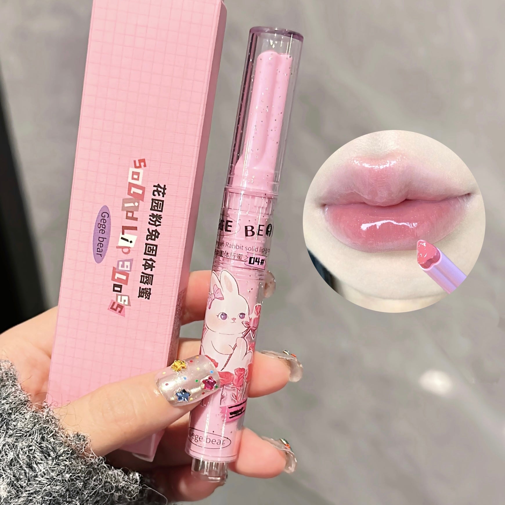 Pink lip balm with cartoon design held by a hand, close-up of lips with lip balm applied.