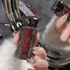 Person holding a perfume bottle with a dog-shaped cap in front of a mirror.