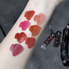 Lipstick swatches on a person's arm with lipsticks below