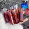 Hand holding multiple Gege Bear lip glosses with a blurred background
