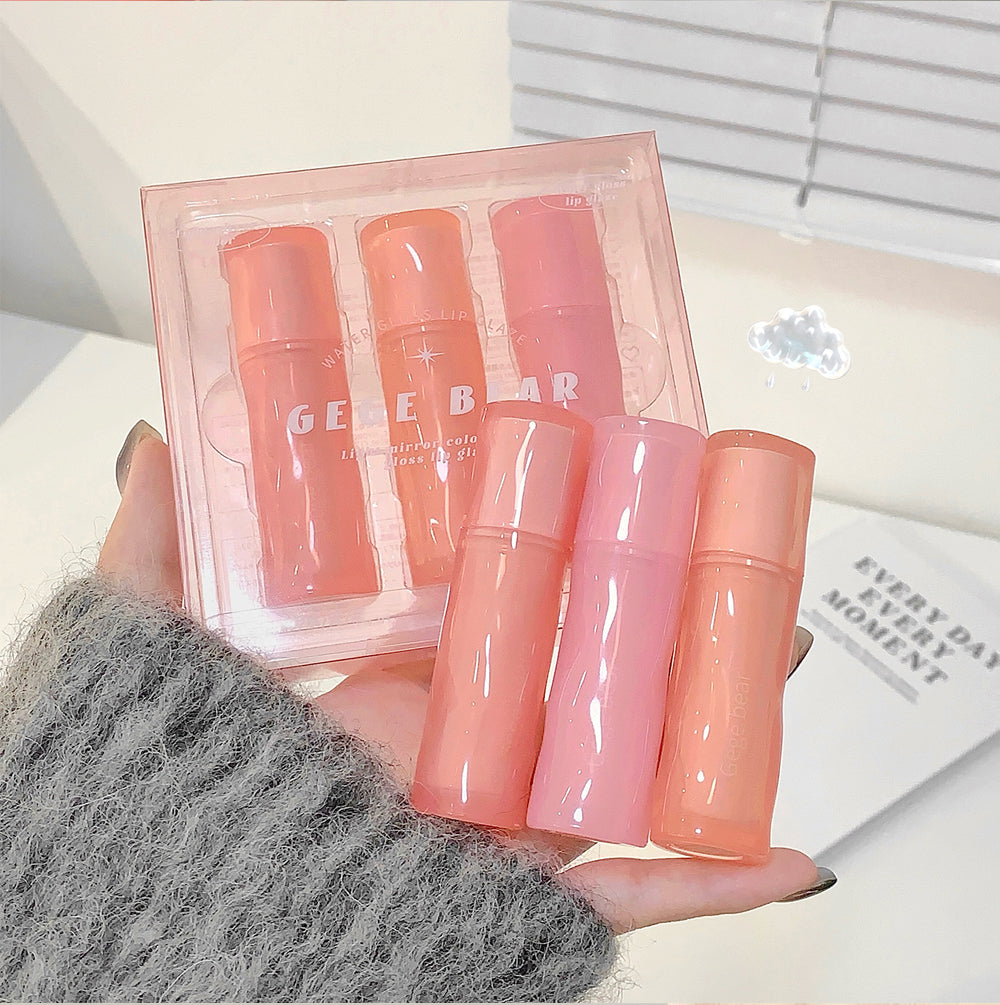 Set of pink skincare products with 'GEBEA' branding held by a person.