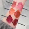 Lipstick swatches on a person's arm with color names labeled.