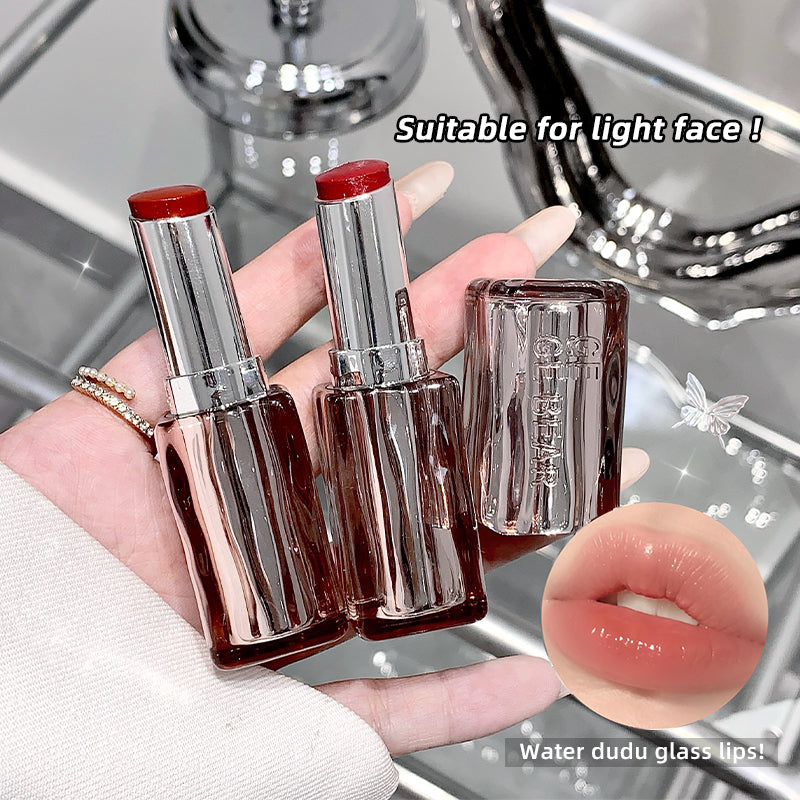 Three lipsticks held in a hand with a close-up of lips wearing the lipstick color, set against a blurred background.