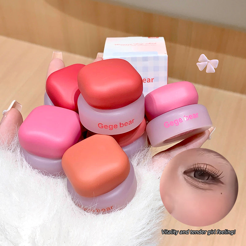 Pink and red compact mirrors with 'Gege bear' branding on a wooden surface.
