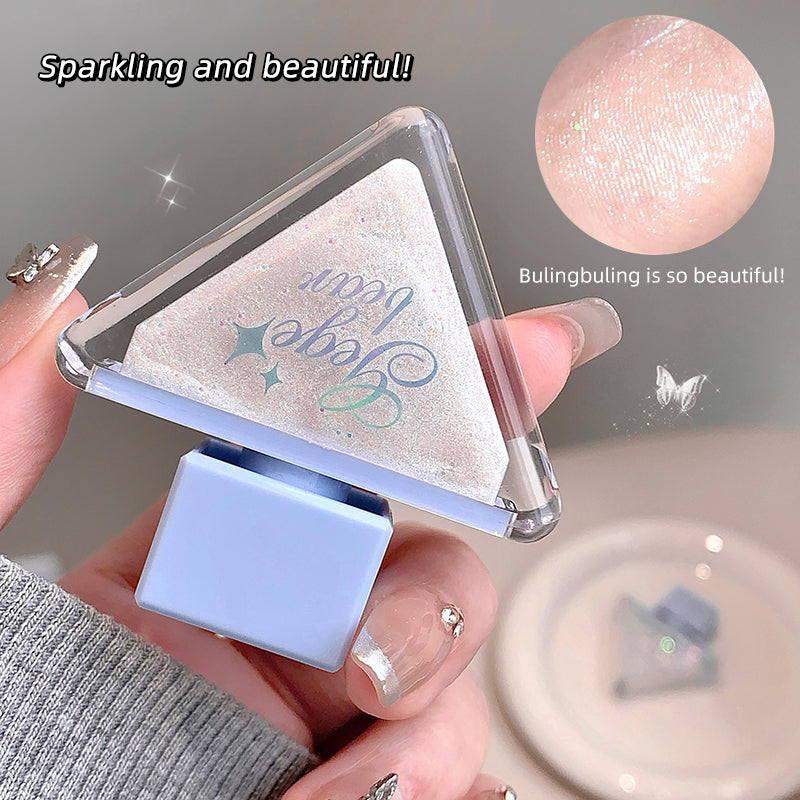 Hand holding a small triangular mirror with 'Bulgingbuling' branding, showing a close-up of the product.