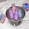 Set of small perfume bottles in various colors on a round metallic stand.