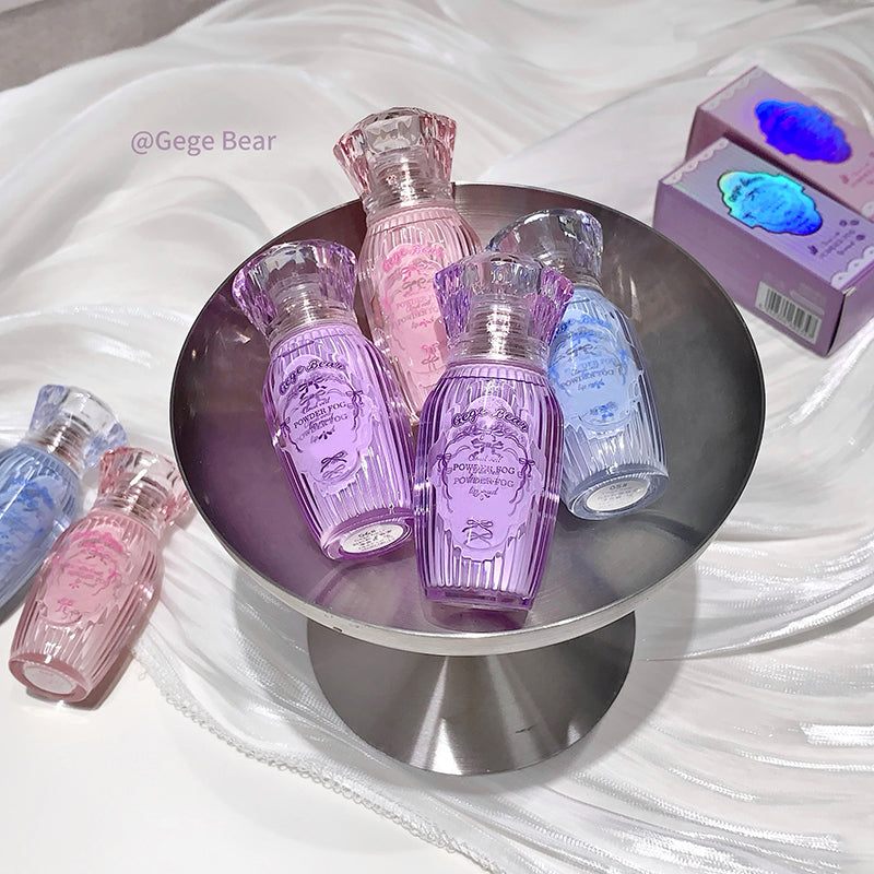 Set of small perfume bottles in various colors on a round metallic stand.