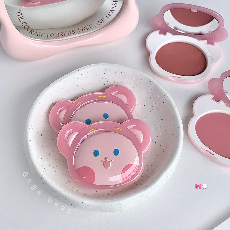Pink bear-shaped containers on a white plate with a pink background