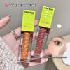 Two GEGE BEAR blush liquids with wooden applicators held by a hand, against a neutral background.