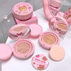 Pink cosmetic compact with bear design on a white background