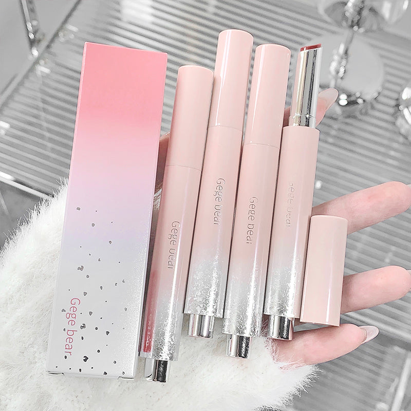Set of pink lip products with a Gege bear box on a blurred background