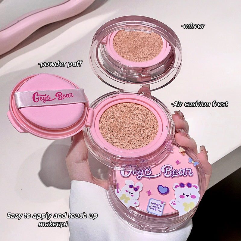 Pink cosmetic compact with 'Gee & Bear' branding, showing powder puff, mirror, and air cushion frost.