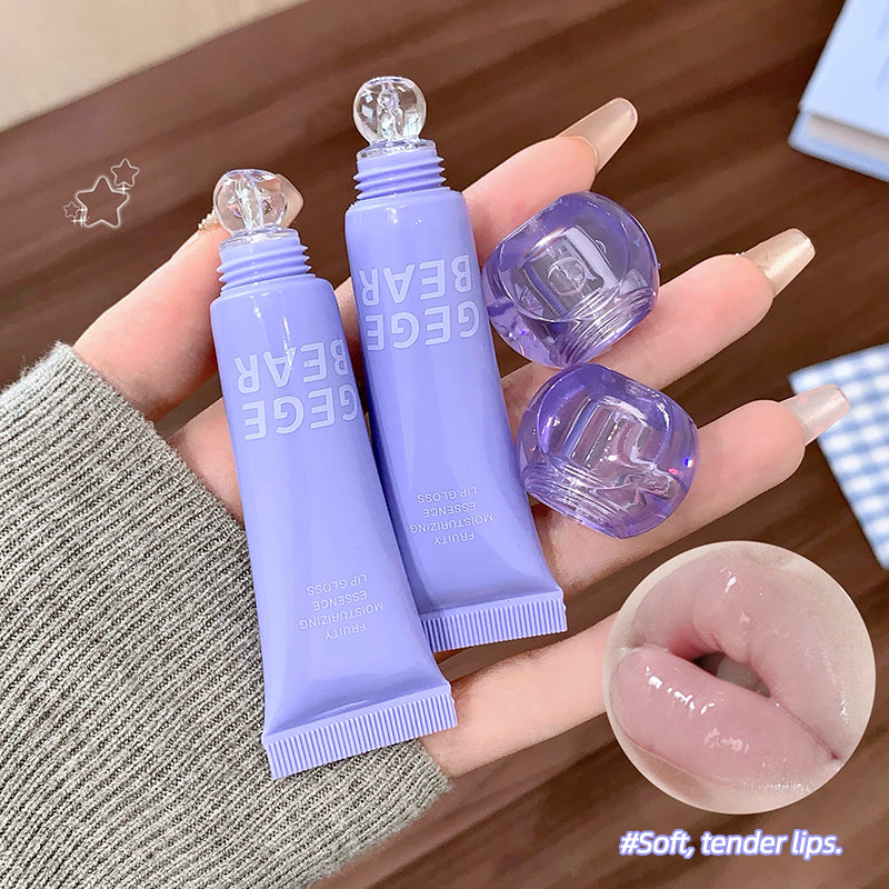 Purple lip balm tubes with visible brand name on a wooden surface