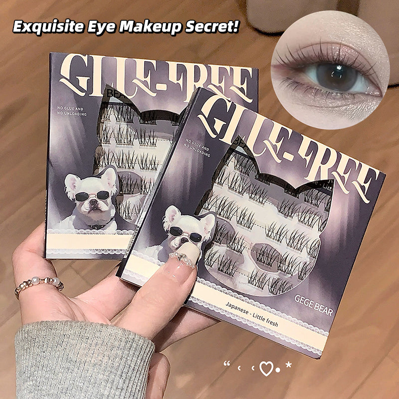 Three pairs of false eyelashes in packaging with a hand holding them, on a wooden surface.