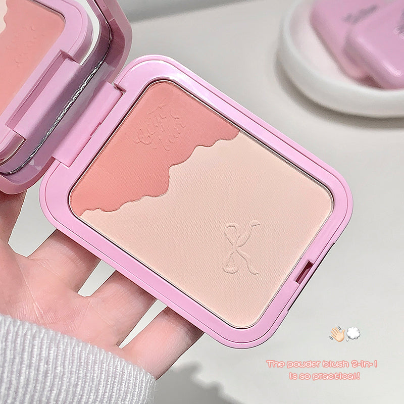 Compact powder blush with pink case held by a hand on a light background
