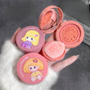 Pink makeup compact with cartoon character design held by a hand on a gray background