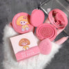 Pink compact powder with cartoon character design on a gray surface