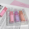Set of small cylindrical products with 'Gege bear' branding in a clear packaging on a newspaper background.