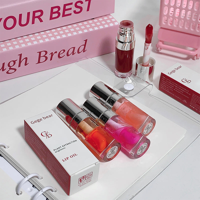 Lip oil products with visible brand name on a white surface