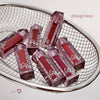 Red lip glosses with 'Gege Bear' branding in a metal basket