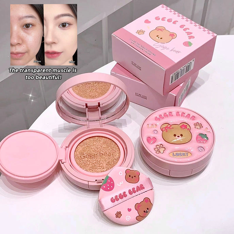 Pink cosmetic compact with bear design on a white surface