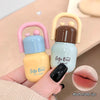 Two small lip balm containers with 'Gege Bear' branding held by a hand.