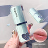 Lip gloss with 'Gege bear' branding held by a hand, close-up of lips with gloss applied.