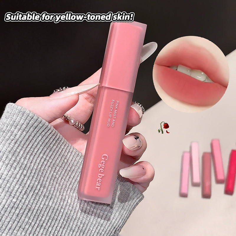 Pink lip gloss held by a hand with close-up of lips wearing the product, suitable for yellow-toned skin.