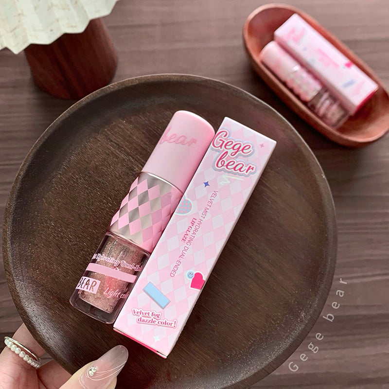 Pink lip gloss with packaging on a wooden plate