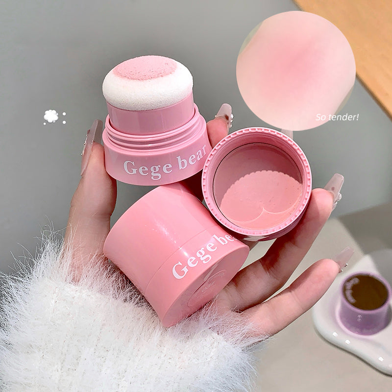Pink makeup product with 'Gege bear' branding held by a hand against a neutral background.